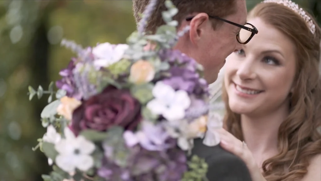 Bride smiling at her groom during an outdoor wedding portrait session
