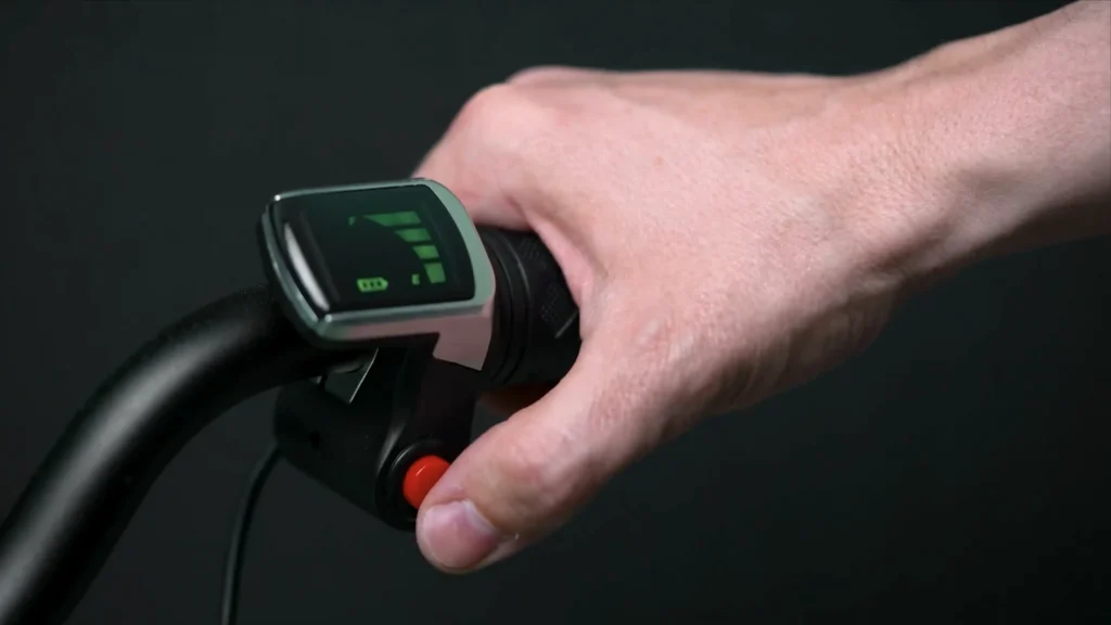 Hand adjusting speed settings on a Superbolt electric balance bike controller