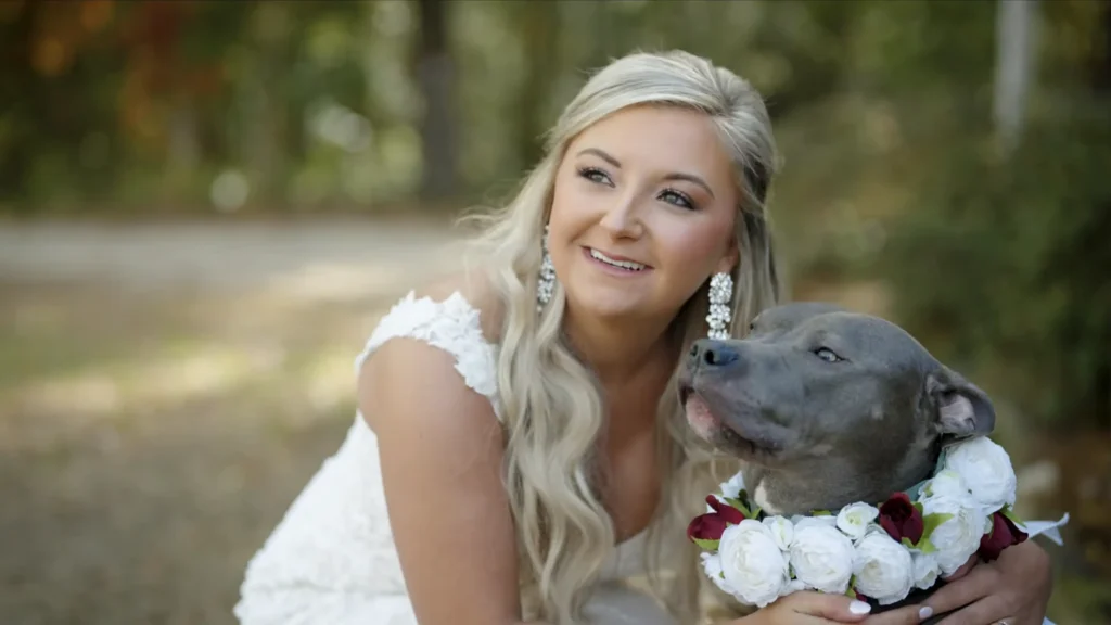 Bride posing with her dog during Amber and Casey's wedding celebration