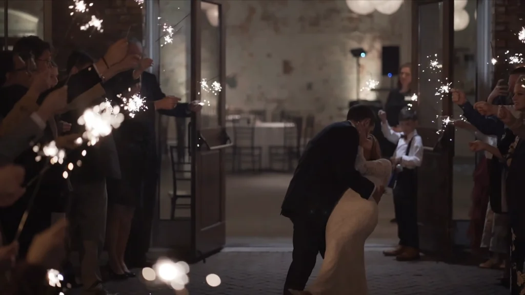 Bride and groom share a kiss during a sparkler exit at their wedding reception at 701 Whaley in Columbia, South Carolina