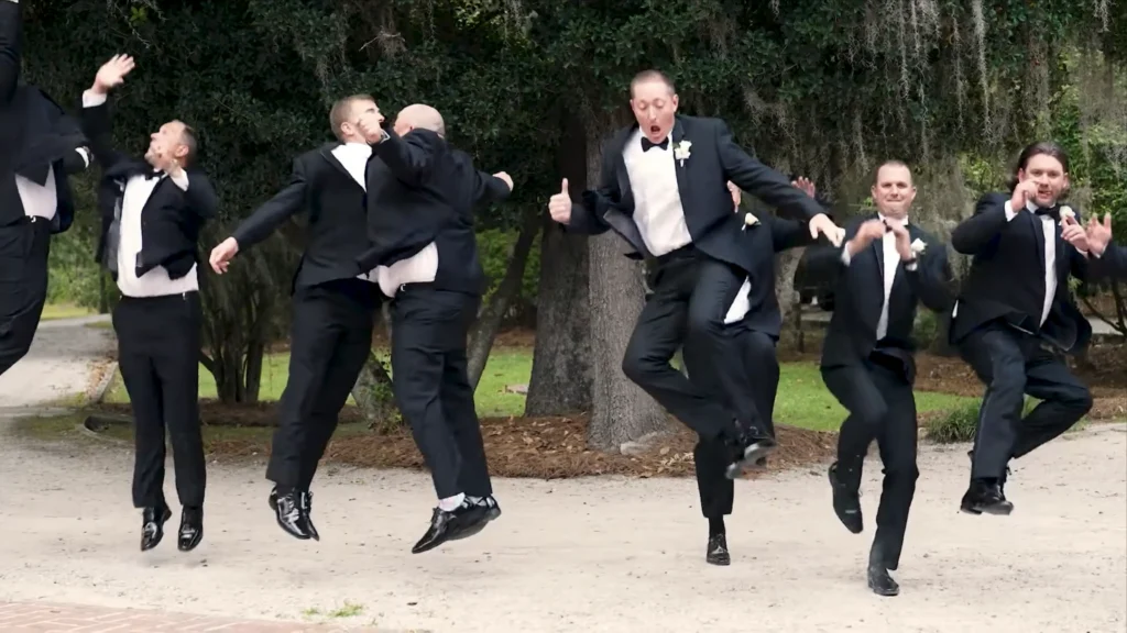 Groomsmen jumping in celebration during Katrina and Hardee's wedding in South Carolina